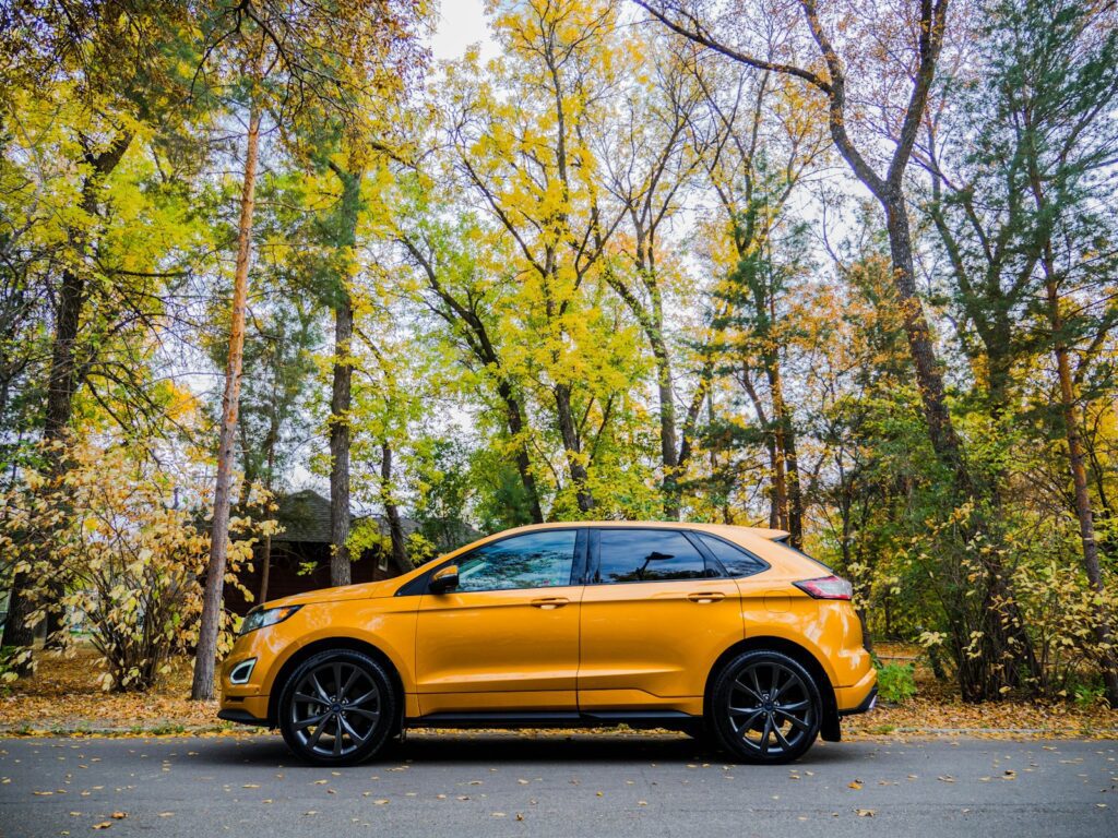 yellow car parked on the side of the road