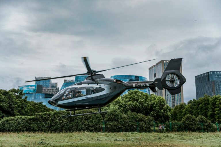 gray and black helicopter flying over the ground